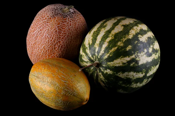 Melons and watermelon on black background — Stock Photo, Image