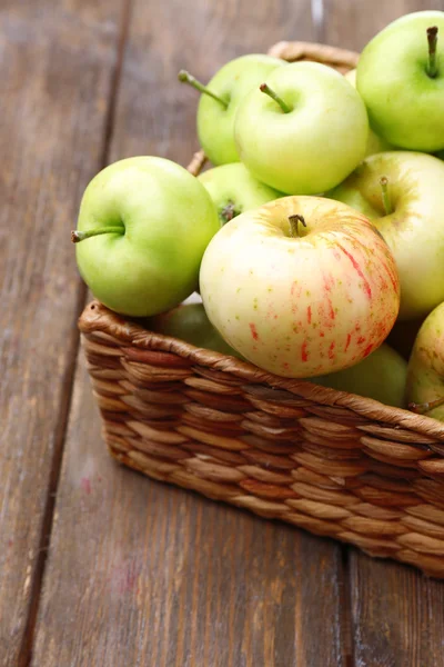 Manzanas maduras en cesta sobre mesa de madera de cerca —  Fotos de Stock