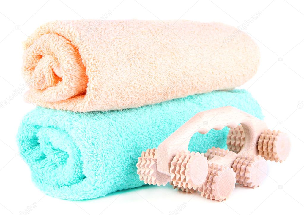 Wooden roller brush and towels on white background isolated