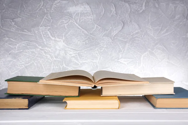 Books on wooden table on light background — Stock Photo, Image