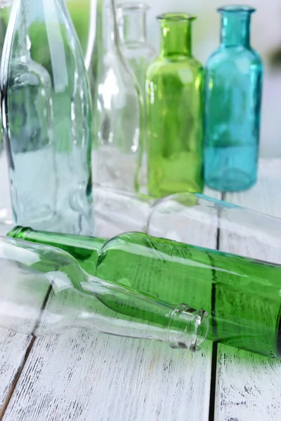 Empty glass bottles on table close-up — Stock Photo, Image