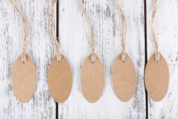 Brown tags on wooden background — Stock Photo, Image