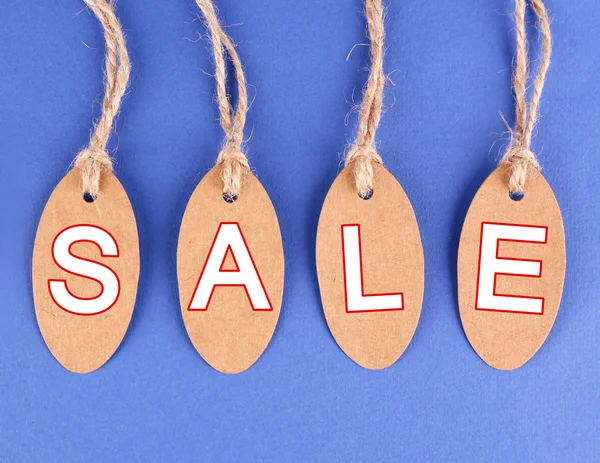 Sale tags on blue background — Stock Photo, Image