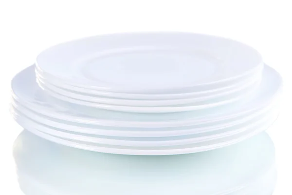 Set of white dishes on table on light background — Stock Photo, Image