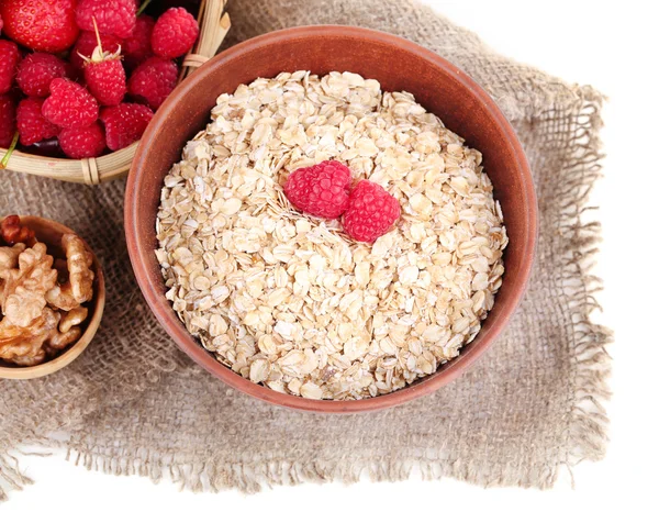 Wooden bowls of berries on sackcloth isolated on white — Stock Photo, Image