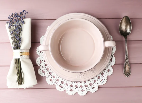 Dining table setting with lavender flowers on wooden table background