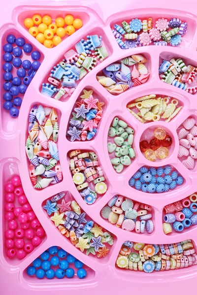 Multicoloured beading kit for children in a pink box — Stock Photo, Image