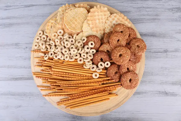 Dry breakfast and biscuits in a big round bowl on grey wooden background — Stock Photo, Image