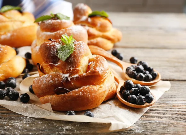 Tasty buns with berries on table close-up — Stock Photo, Image