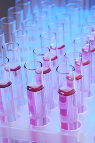 Test tubes with lilac liquid closeup — Stock Photo, Image