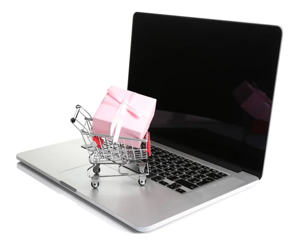 Shopping cart on laptop with gift box isolated on white — Stock Photo, Image