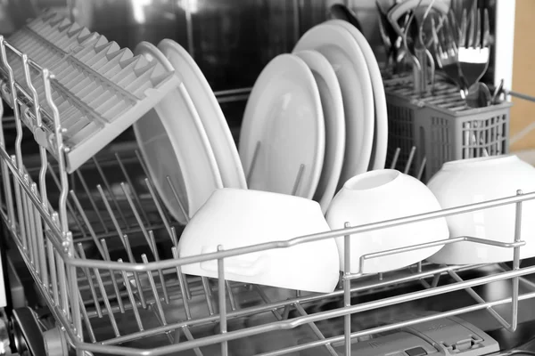 Open dishwasher with clean utensils in it — Stock Photo, Image