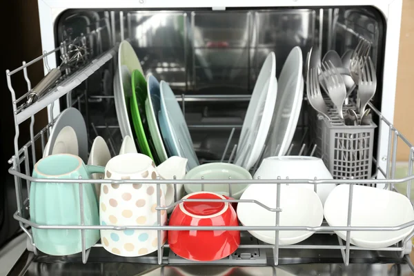 Open dishwasher with clean utensils in it — Stock Photo, Image