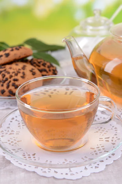 Teapot and cup of tea on table on bright background — Stock Photo, Image