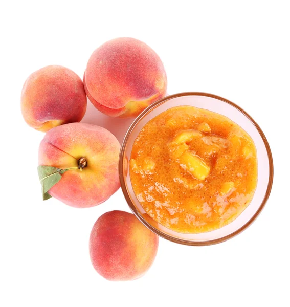 tasty peach jam with fresh peaches, isolated on white