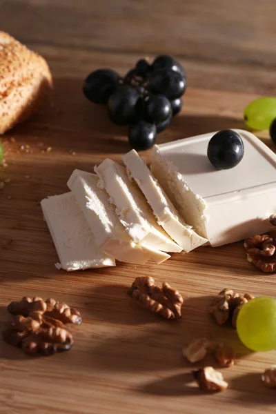 Still life with tasty cheese, grape and bread, close up — Stock Photo, Image