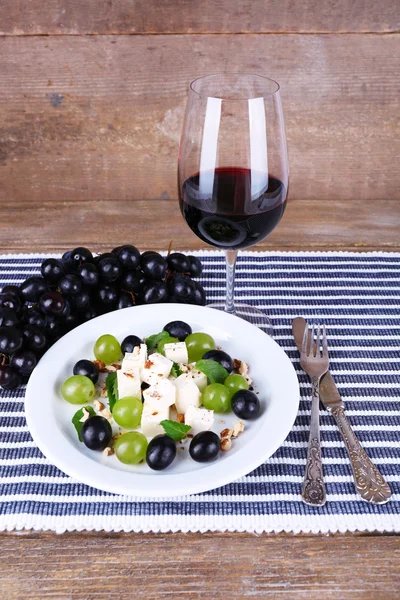 Beautiful still life with wine and salad on wooden background — Stock Photo, Image