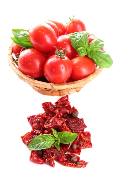 Sun dried tomatoes, fresh tomatoes in wicker basket,  basil leaves, isolated on white — Stock Photo, Image