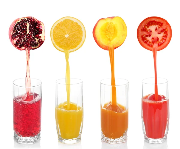 Juice pouring from fruits and vegetables into glass, isolated on white — Stock Photo, Image