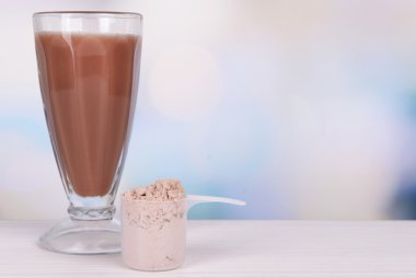 Tablo parlak zemin üzerine peynir altı suyu protein tozu ve çikolata protein shake