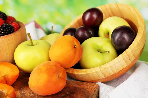 Ripe fruits and berries on table on bright background — Stock Photo, Image