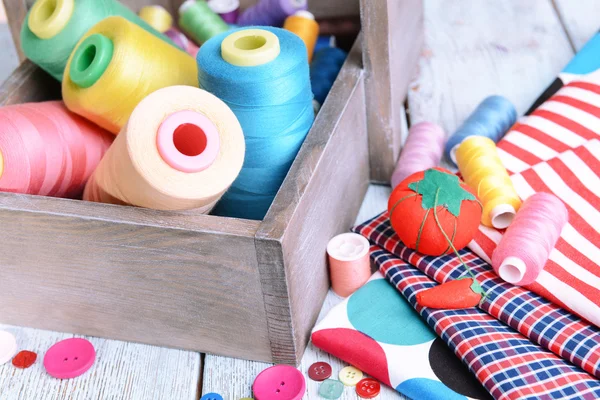 Sewing Accessories in wooden box on table close-up — Stock Photo, Image