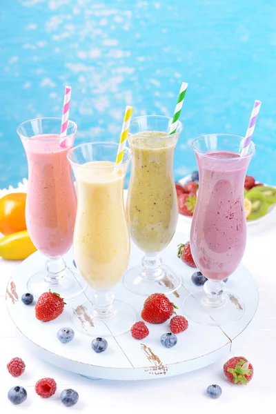 Delicious berry cocktails on table on water background — Stock Photo, Image