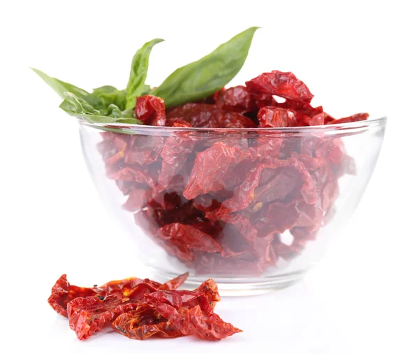 Sun dried tomatoes in glass bowl and basil leaves, isolated on white — Stock Photo, Image