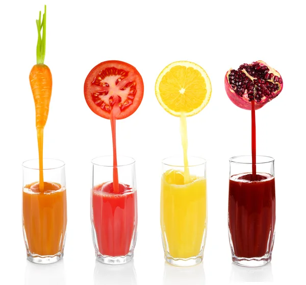 Juice pouring from fruits and vegetables into glass, isolated on white — Stock Photo, Image