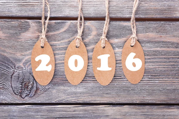 New year tags on wooden background — Stock Photo, Image