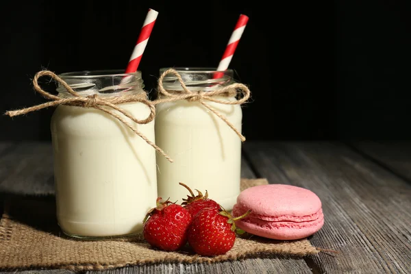 Milk in bottles with paper — Stock Photo, Image