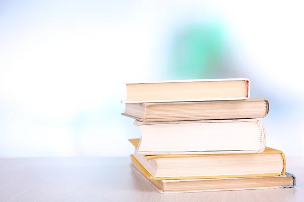 Books on wooden table on natural background — Stock Photo, Image