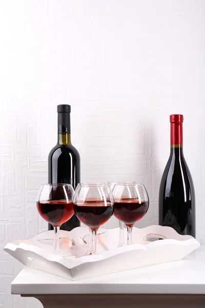 Bicchieri e bottiglia di vino su vassoio in camera — Foto Stock