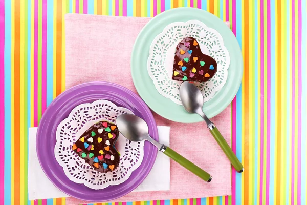 Delicious rainbow mini cakes on plates, on bright background — Stock Photo, Image