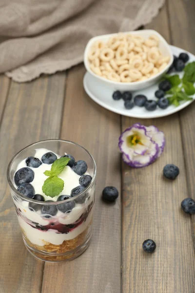 Yogurt alami dengan buah berry segar di atas meja kayu — Stok Foto