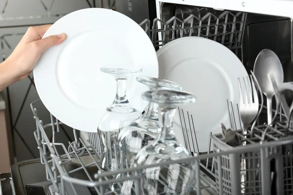 Open dishwasher with clean utensils in it — Stock Photo, Image