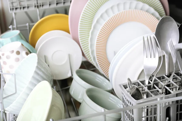 Open dishwasher with clean utensils in it — Stock Photo, Image