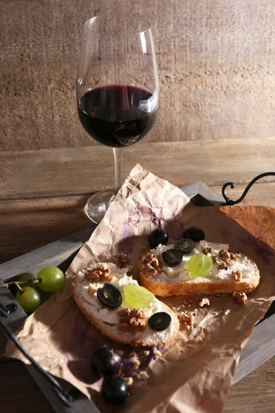 Beautiful still life with wine, cheese and ripe grape on wooden background — Stock Photo, Image