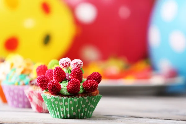 Delicious birthday cupcakes on table on bright background — Stock Photo, Image