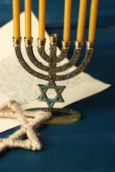 Menorah, star of David and page of Genesis book on wooden background — Stock Photo, Image