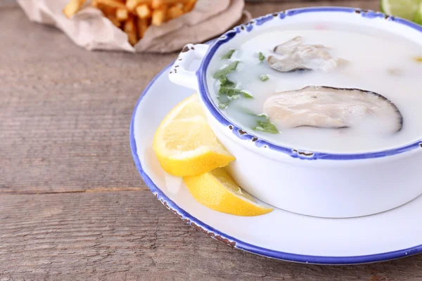 Tasty soup with oysters on wooden table — Stock Photo, Image