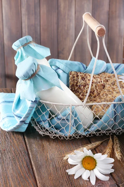 Tasty snack in basket on wooden background indoor — Stock Photo, Image