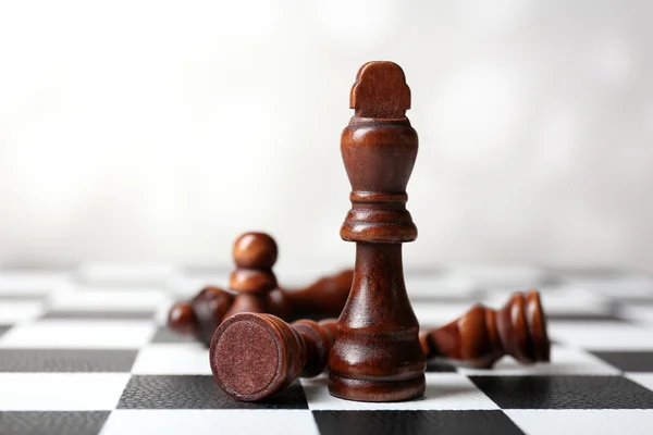 Chess board with chess pieces on grey background — Stock Photo, Image