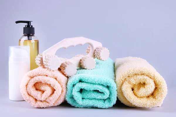 Brosse à rouleaux en bois, serviettes et kit de douche sur fond gris — Photo