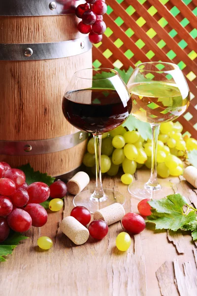 Wijn met druiven op tafel op bruine achtergrond — Stockfoto