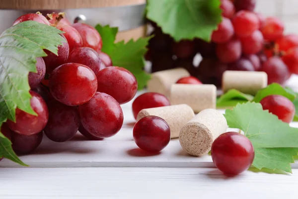 Rolhas de garrafa de vinho com uvas em close-up de mesa — Fotografia de Stock