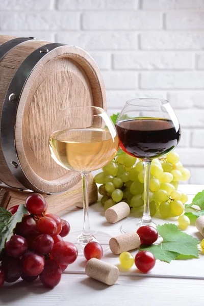 Wijn met druiven op tafel op bakstenen muur achtergrond — Stockfoto