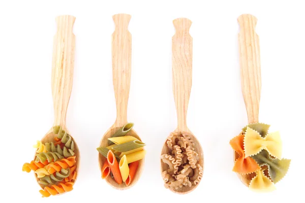 Assortment of colorful pasta in wooden spoons isolated on white — Stock Photo, Image