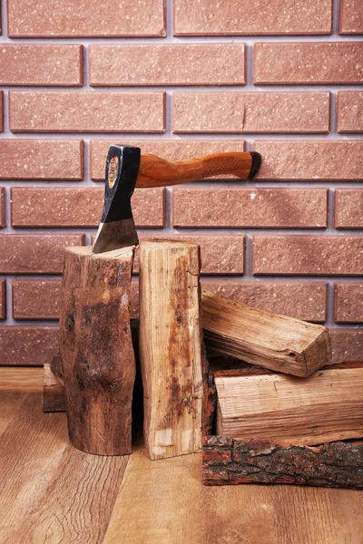 Firewood and axe on floor — Stock Photo, Image