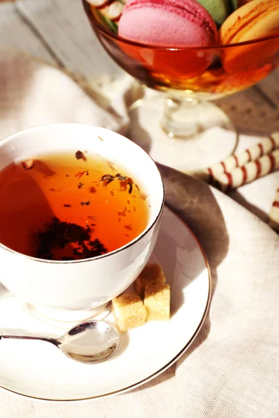 Cup of tea with macaroons on table, close up — Stock Photo, Image